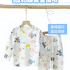 White and pastel patterned cotton pajama set for children, featuring long sleeves and pants.