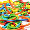 A colorful assortment of wooden rings and sticks used for a Montessori early learning puzzle toy.
