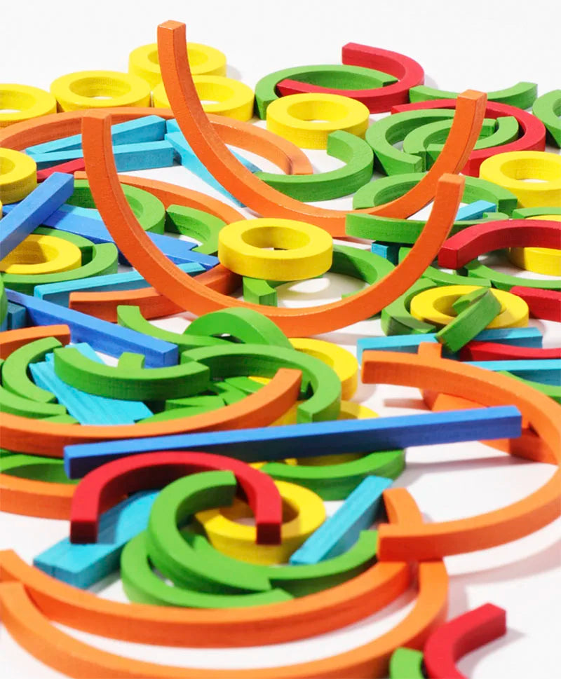 A colorful assortment of wooden rings and sticks used for a Montessori early learning puzzle toy.