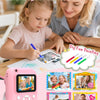 A pink instant print camera for kids is shown being used by a girl and a woman, with various photo prints displayed.
