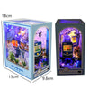 A wooden book nook kit featuring an underwater scene illuminated by LED lights.
