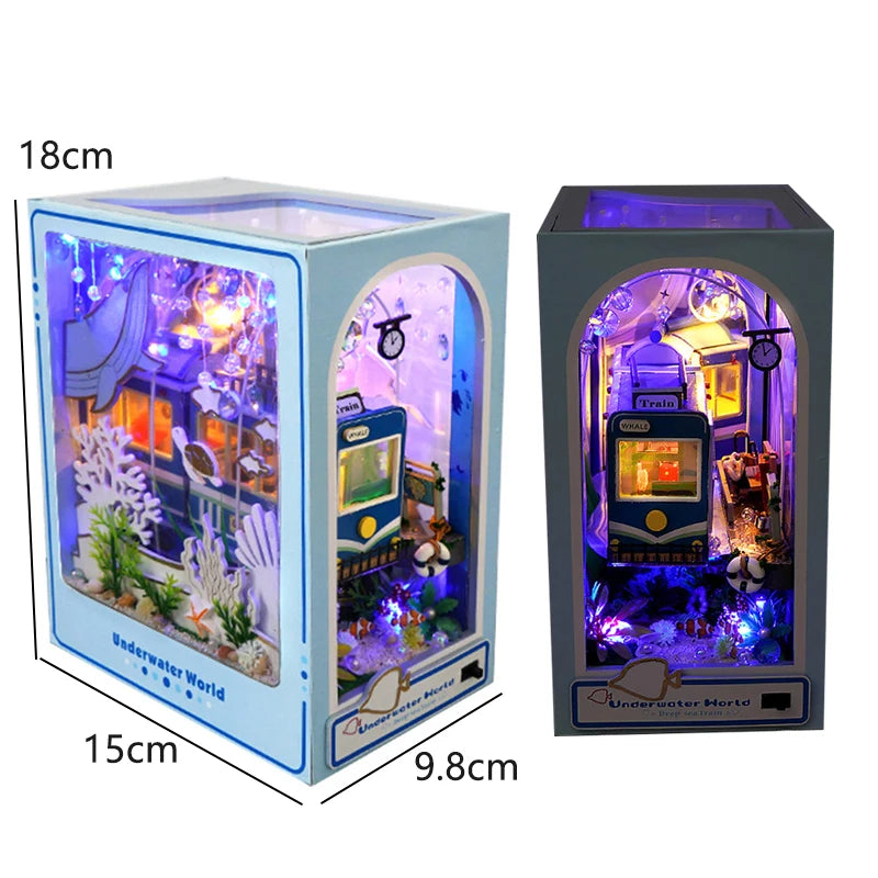 A wooden book nook kit featuring an underwater scene illuminated by LED lights.