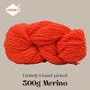 A ball of bright orange merino wool yarn labeled as Lirisnly's hand-picked 300g Merino.