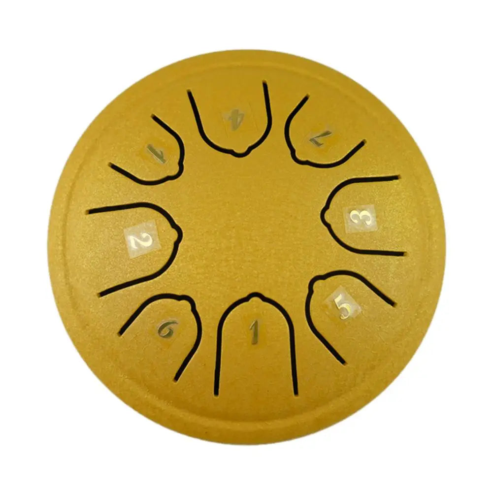 A round, golden steel tongue drum with numbered holes and mallets.