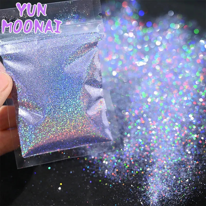 A small plastic bag of holographic rainbow nail glitter fine sparkle dust is shown spilling out onto a dark surface.