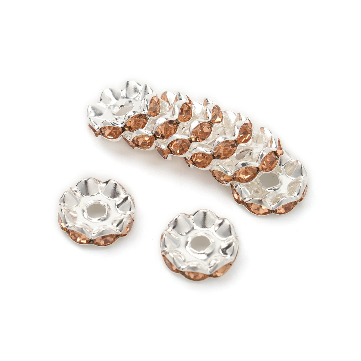 A row of 12mm crystal rhinestone spacer beads in a rose gold tone for jewelry making.