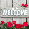 A rustic wooden sign with the word WELCOME and red roses, set against a weathered wooden background.