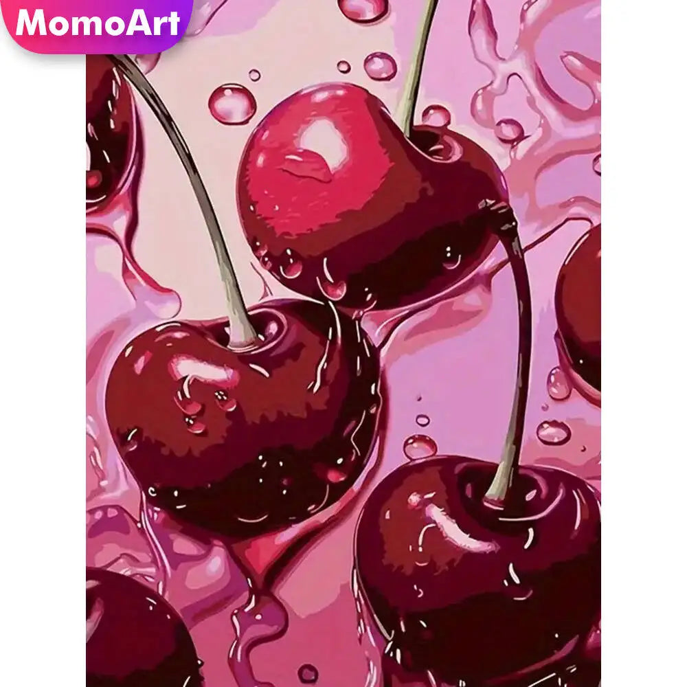 A close-up of a glossy, deep red cherry fruit with a stem against a pink background.