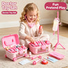A young girl is playing with a pink doctor toy set including a stethoscope and various medical props on a rolling trolley.