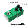 A green analog delay pedal with three knobs and a bypass switch, shown next to its power cable.