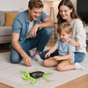 A family is playing on a rug with a green wall-climbing RC gecko toy.