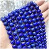 A hand holds a string of deep blue natural stone beads for DIY jewelry making