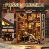 A wooden model kit of a fossil museum display featuring various dinosaur skeletons and geological elements.