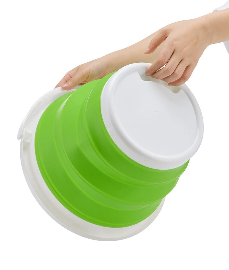 A hand is holding a bright lime green collapsible bucket with a white lid.