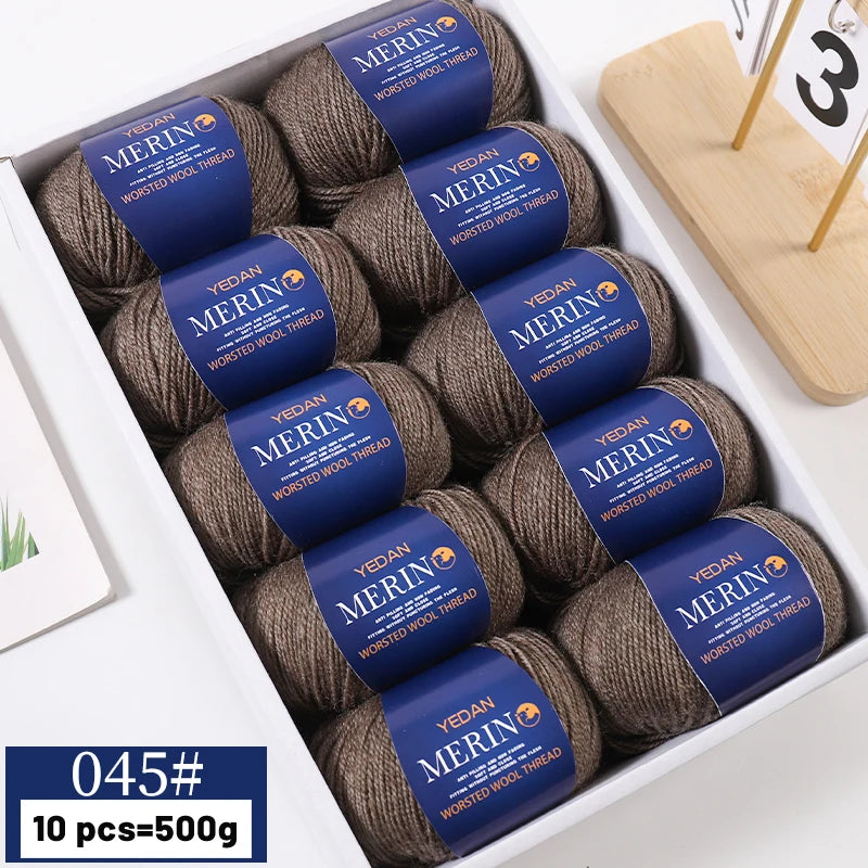 A box of YEDAN MERIN worsted wool thread yarn balls for knitting projects.