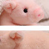 Close-up detail display of a pink plush pig stuffed animal showing its soft texture and features.