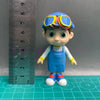 A playful cartoon PVC figurine of a child wearing an orange and blue school bus helmet and blue overalls.