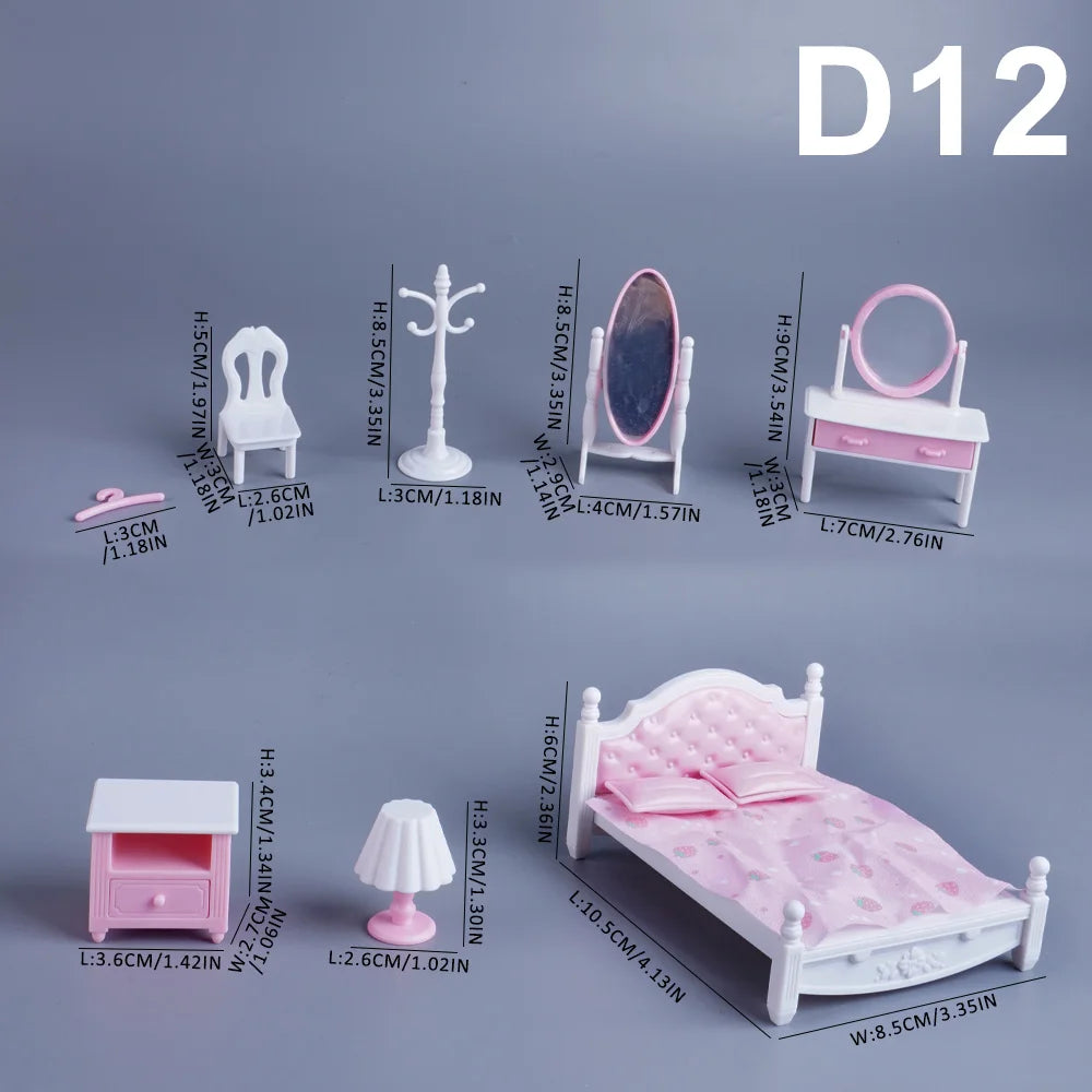A set of 1:12 scale dollhouse furniture including a pink bed, dresser, mirror, and toilet accessories.