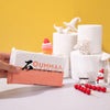 A hand holds a block of pink air-dry clay next to white sculpted figures on a yellow background.
