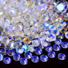 A pile of sparkling crystal flatback rhinestones in various shades of clear, white, and blue.