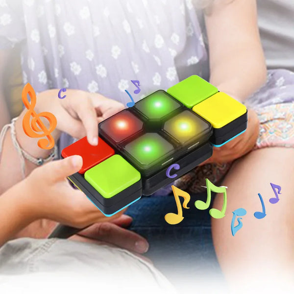 A hand is interacting with a handheld fidget puzzle cube featuring colored gems, lights, and musical notes.