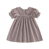 A plaid A-line dress for a toddler girl featuring a Peter Pan collar and short sleeves.