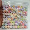 A clear plastic bag filled with numerous pastel-colored, squishy cat paw shaped fidget toys.