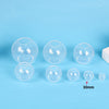 A collection of clear silicone sphere molds used for resin crafting, showing various sizes and shapes.