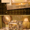 A vintage-style wooden miniature dollhouse kit featuring a vitrine with various accessories and jewelry displayed.