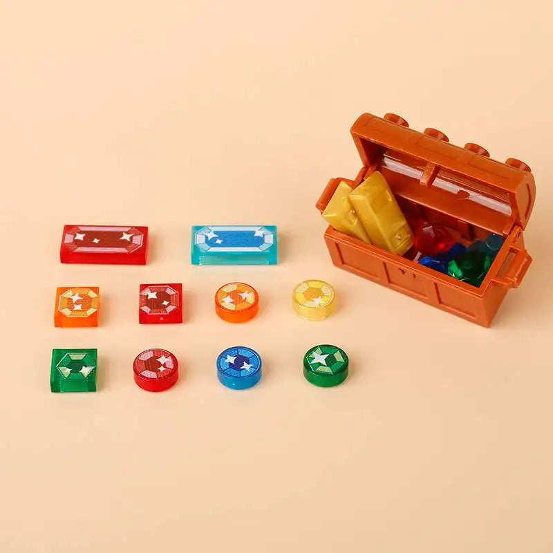 An open wooden treasure chest filled with gold and silver coins, surrounded by various colored building blocks.