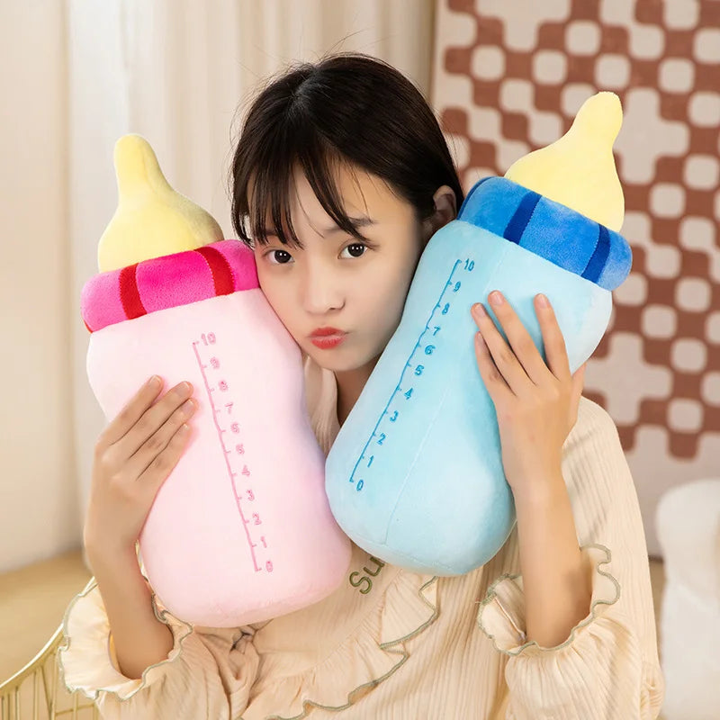 A woman holds a light blue milk bottle plush pillow with yellow and blue accents.