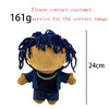 A dark blue plush doll with dreadlocks and a silver chain necklace.