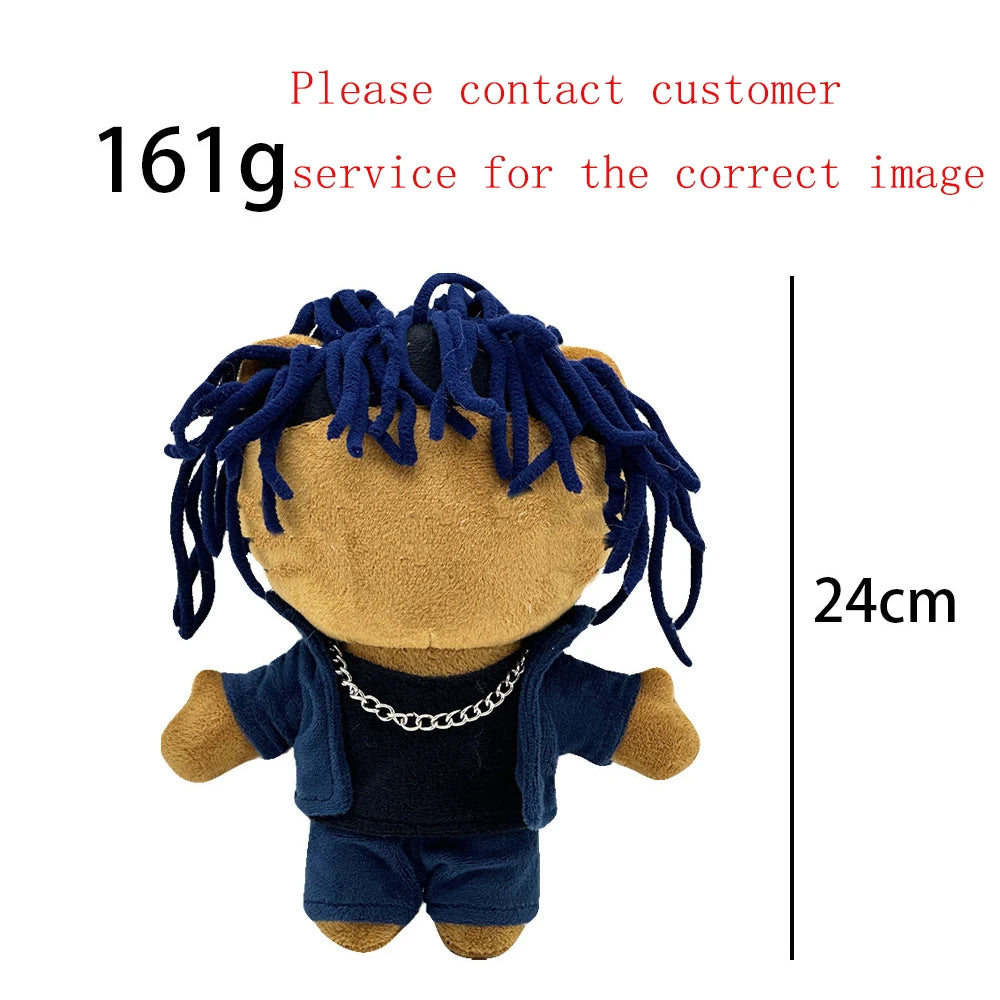 A dark blue plush doll with dreadlocks and a silver chain necklace.