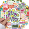 A hand holds a sticker pack featuring positive affirmation phrases and smiling emojis on a colorful background.