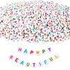 A pile of colorful letter and number acrylic beads for jewelry making