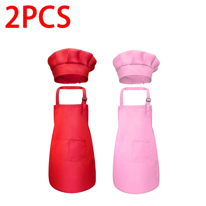 A set of two pink and red chef aprons and hats for kids