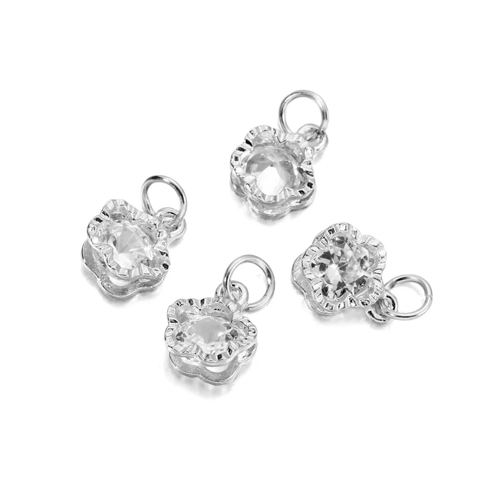 A pair of clear, faceted heart-shaped rhinestone charms for jewelry making, shown against a white background.
