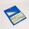 A blue plastic domino set with a clear window showing white and black tiles.