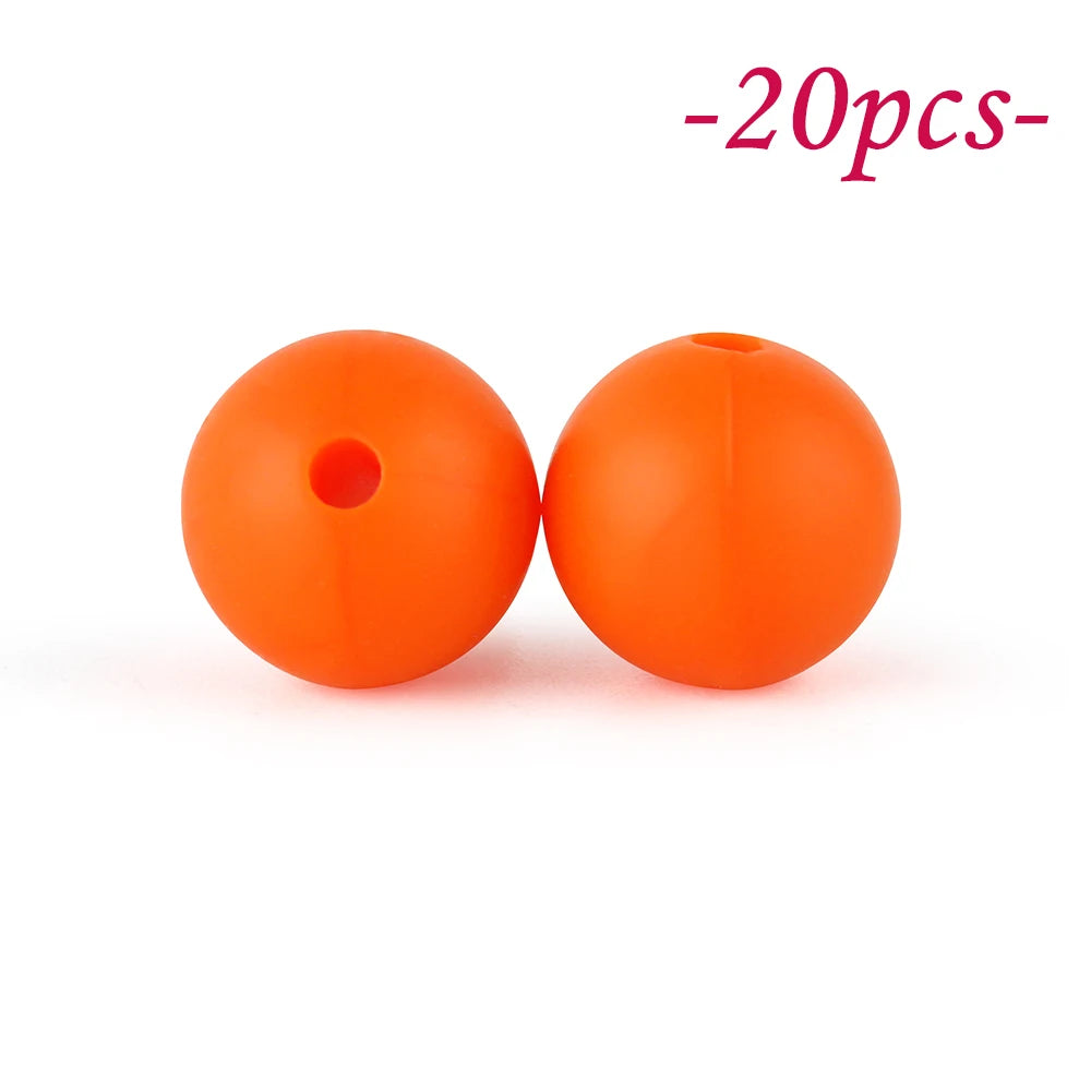 Two bright orange silicone beads are shown against a white background.