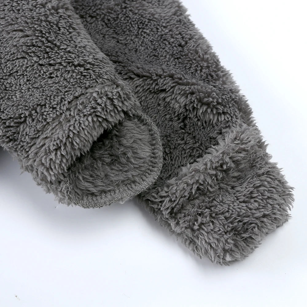 A close-up of a gray, fuzzy baby bear fleece hooded romper with a zipper.