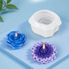 White silicone candle mold with a floral design and a purple silicone flower mold on a blue surface
