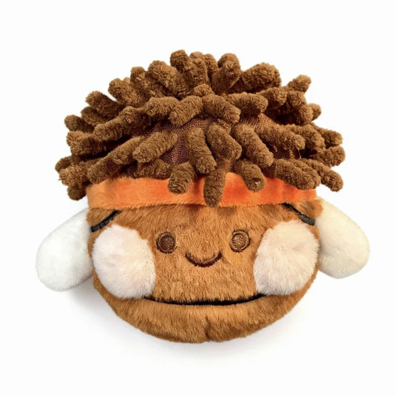 A brown, textured plush charm resembling a stylized face with orange accents.