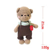 A handmade crochet stuffed bear toy with brown fur and dark brown overalls.