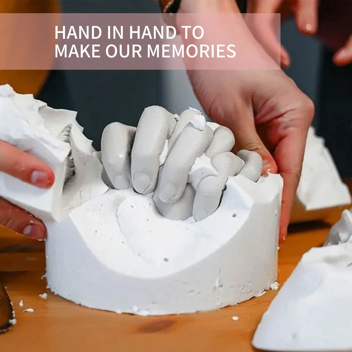 Hands are molding white clay into a keepsake shape for a 3D hand casting kit.