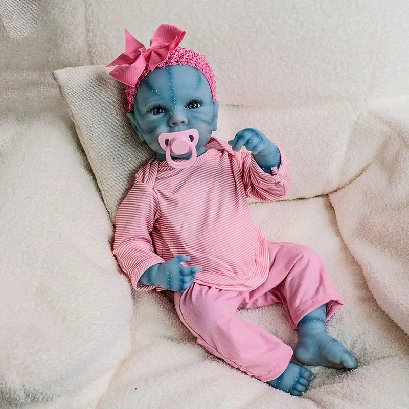 A handcrafted reborn baby doll with a blue silicone vinyl body wearing pink striped clothing and a pink bow.
