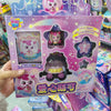 A packaged collectible figure of a pink and white character with purple accents, featuring a dark purple and black themed box