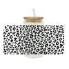 Clear glass jar with a black leopard print wrap and a straw lid.