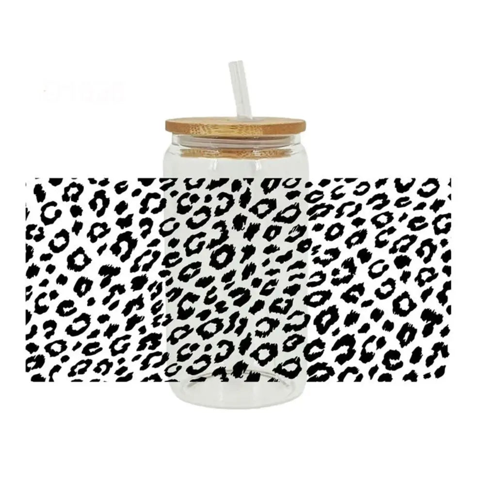 Clear glass jar with a black leopard print wrap and a straw lid.