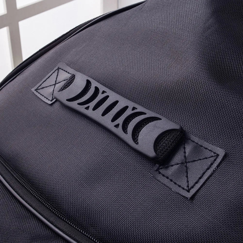 Close-up of a black padded guitar bag featuring a black strap with a geometric design.