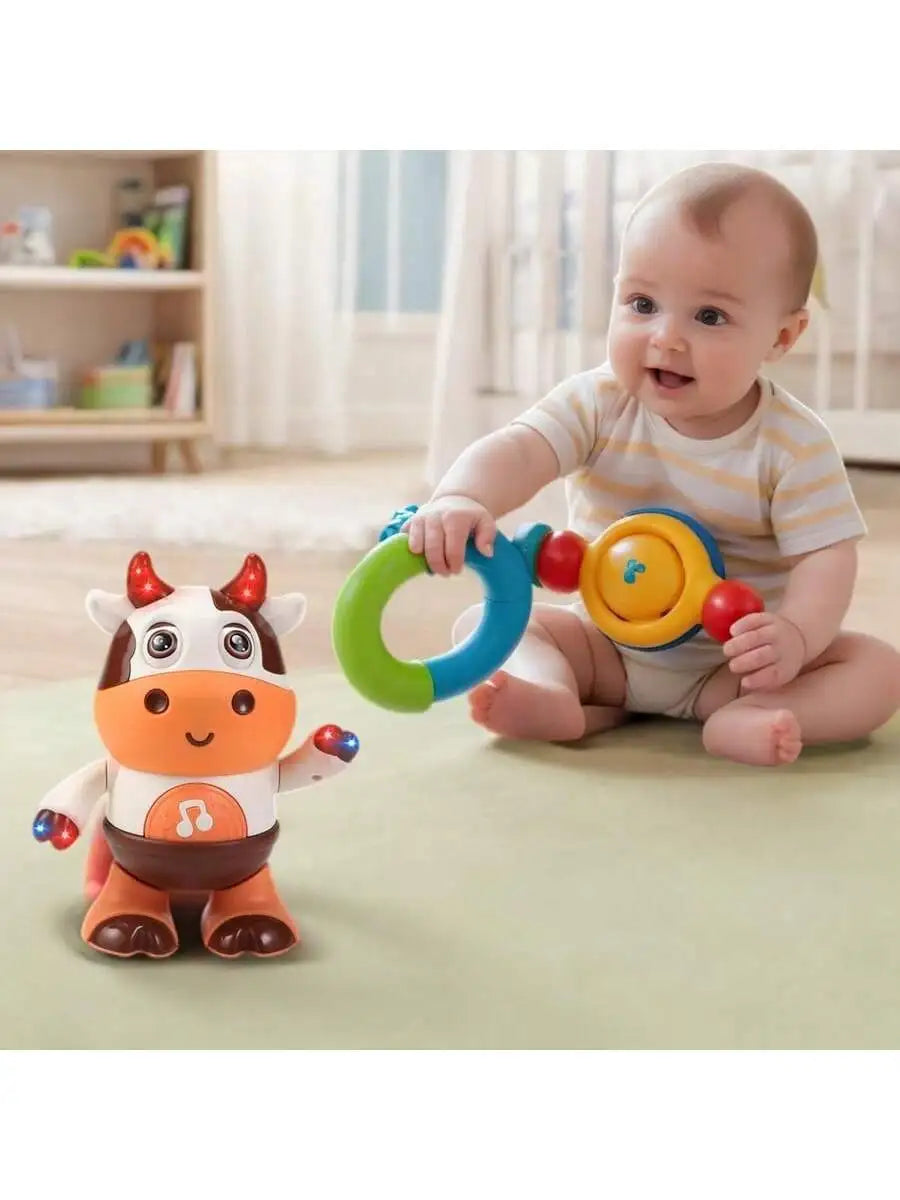 A baby is interacting with an orange and yellow musical toy shaped like a cow, while an orange plush toy cow sits nearby.